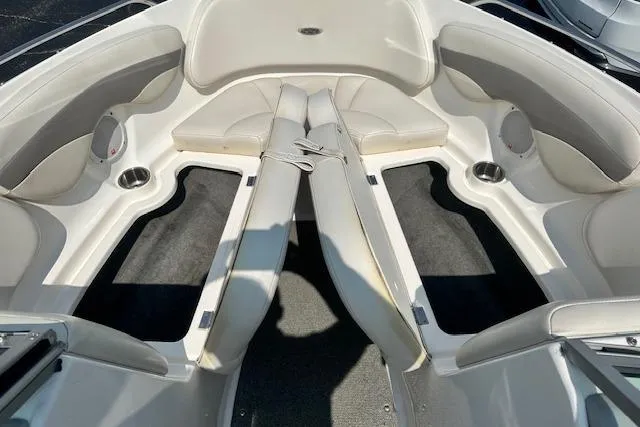 Slide: The Image of 2005 Chaparral 210 SSi boat interior with white seating and cup holders. - 17
