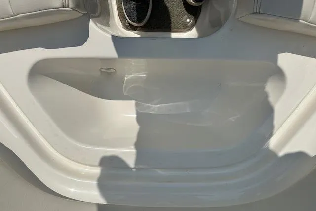 Slide: The Image of Interior view of a 2005 Chaparral 210 SSi boat, featuring white seating and flooring. - 18