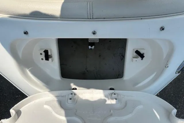 Slide: The Image of 2005 Chaparral 210 SSi boat storage compartment, open and empty, with white interior. - 19