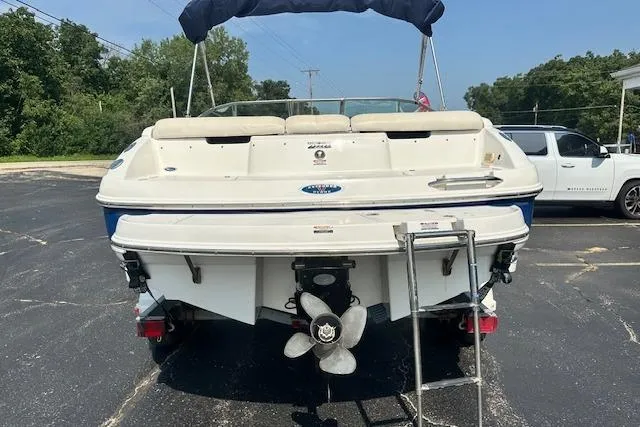 Slide: The Image of 2005 Chaparral 210 SSi boat, rear view with ladder, parked on asphalt. - 2