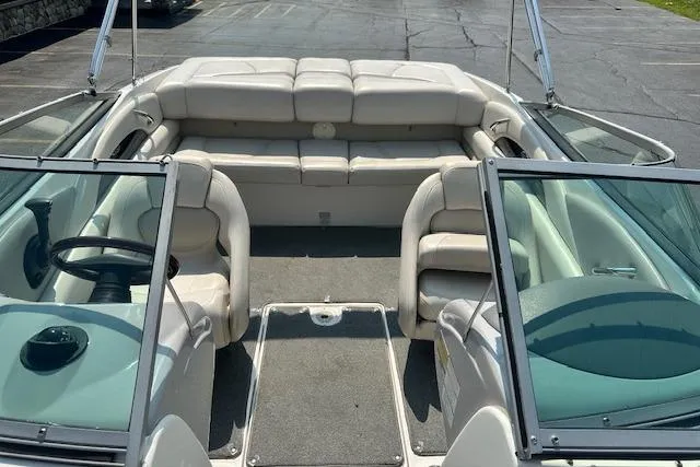 Slide: The Image of 2005 Chaparral 210 SSi boat interior with beige seating and open windshield. - 20