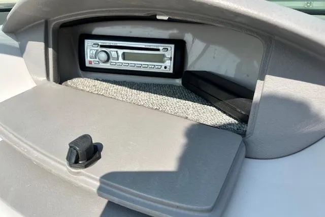 Slide: The Image of 2005 Chaparral 210 SSi boat stereo system in dashboard compartment. - 24