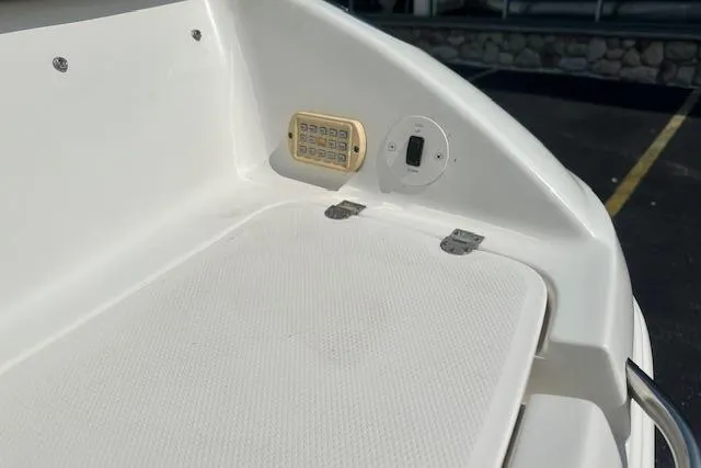 Slide: The Image of 2005 Chaparral 210 SSi boat deck with light and switch, featuring white textured surface. - 3