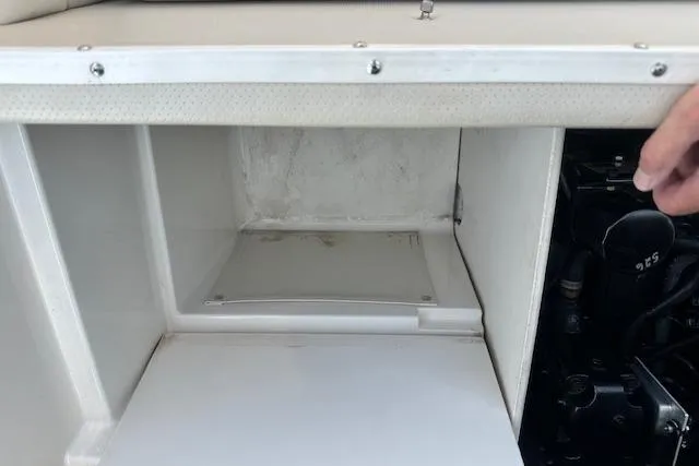 Slide: The Image of Storage compartment in a 2005 Chaparral 210 SSi boat, showcasing interior space. - 30