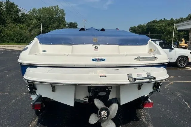 Slide: The Image of 2005 Chaparral 210 SSi boat with blue cover, parked outdoors. - 32
