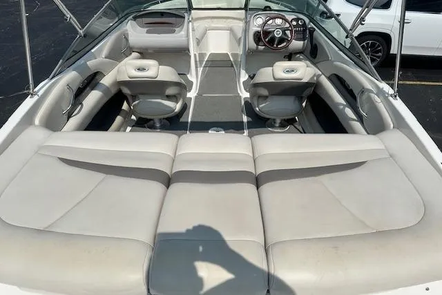 Slide: The Image of 2005 Chaparral 210 SSi boat interior with beige seating and steering wheel. - 4