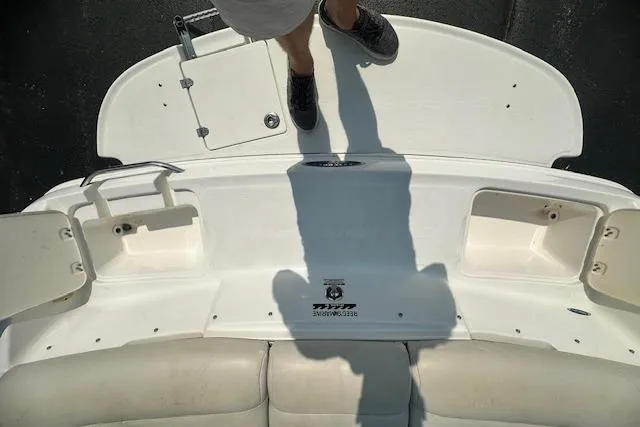Slide: The Image of 2005 Chaparral 210 SSi boat deck with storage compartments and person standing. - 5