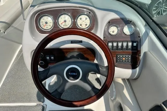 Slide: The Image of Steering wheel and dashboard of 2005 Chaparral 210 SSi boat with gauges and controls. - 9