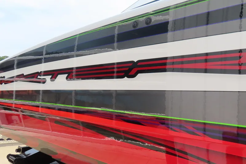 Slide: The Image of Close-up of 2025 Skater 388 boat with vibrant red and green stripes. - 16