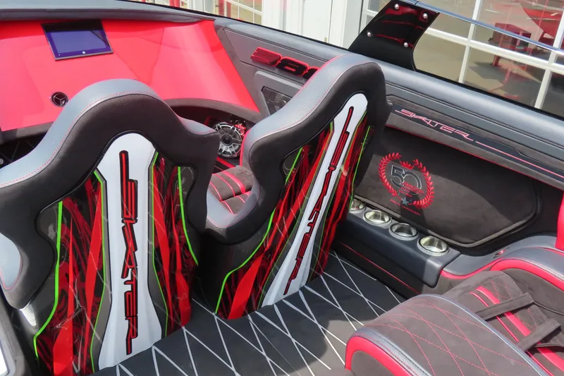 Slide: The Image of Interior of 2025 Skater 388 boat with vibrant red and black design, featuring custom seats. - 23