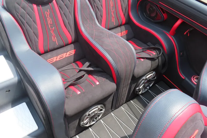 Slide: The Image of Luxurious Skater 388 boat interior, 2025 model, featuring red and black seating with speakers. - 29