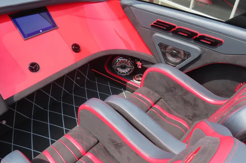 Slide: The Image of Interior of 2025 Skater 388 with red and black design, featuring modern dashboard and seating. - 31