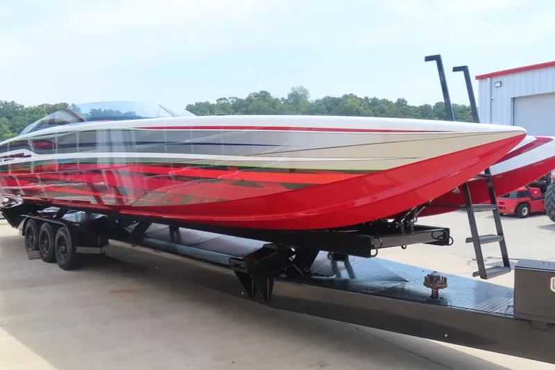 Slide: The Image of 2025 Skater 388 powerboat with vibrant red and white design on a trailer. - 8