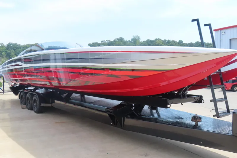 Slide: The Image of 2025 Skater 388 powerboat with vibrant red and white design on a trailer. - 9