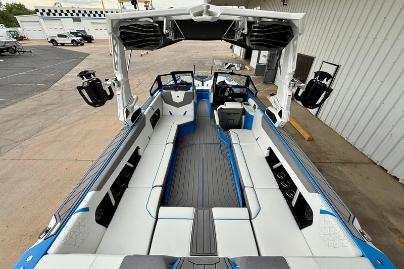 Slide: The Image of 2025 Nautique Super Air Nautique GS24 boat interior with spacious seating and modern design. - 12