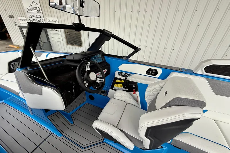 Slide: The Image of 2025 Nautique Super Air Nautique GS24 interior with modern dashboard and seating. - 13