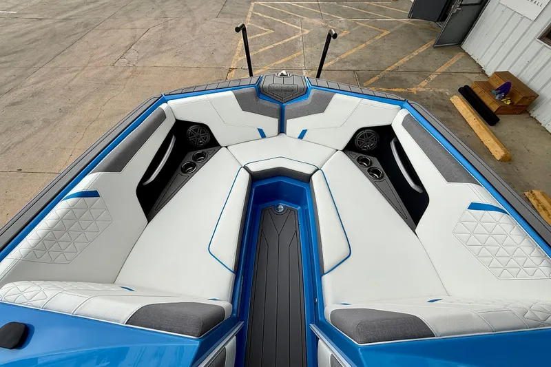 Slide: The Image of 2025 Nautique Super Air Nautique GS24 boat interior with white and blue seating. - 15