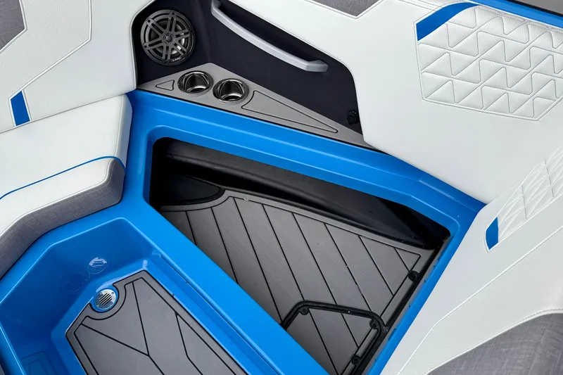 Slide: The Image of 2025 Nautique Super Air Nautique GS24 interior with blue accents and cup holders. - 17