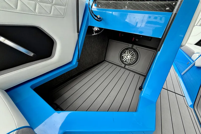Slide: The Image of 2025 Nautique Super Air Nautique GS24 interior with blue accents and speaker system. - 20