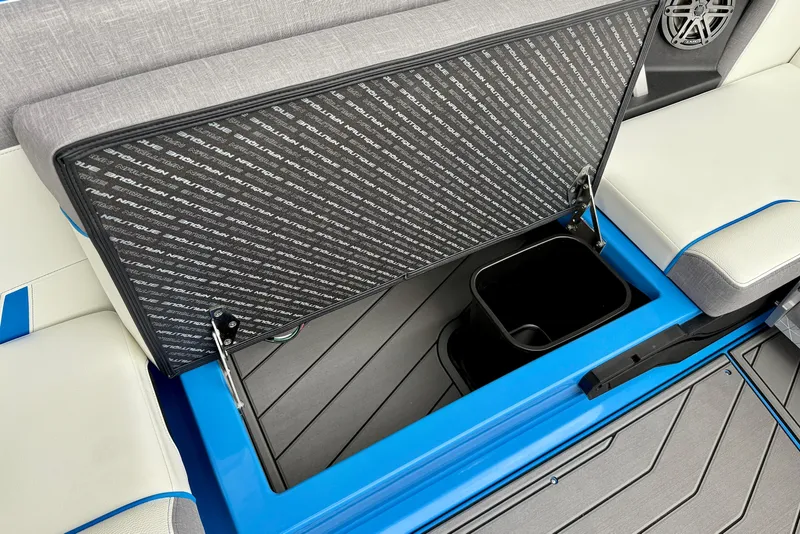 Slide: The Image of 2025 Nautique Super Air Nautique GS24 storage compartment with open lid and seating. - 25