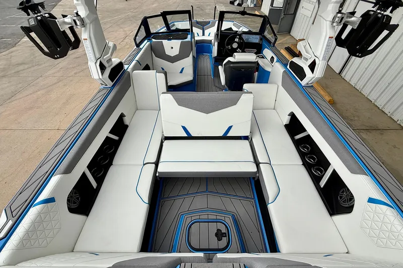 Slide: The Image of 2025 Nautique Super Air Nautique GS24 interior with white and blue seating, modern design. - 26