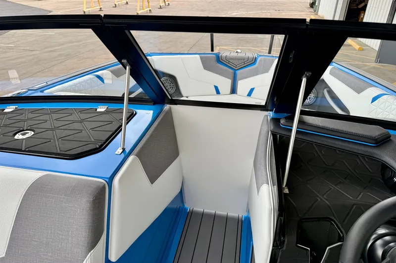 Slide: The Image of 2025 Nautique Super Air Nautique GS24 interior with blue and gray seating and sleek design. - 32