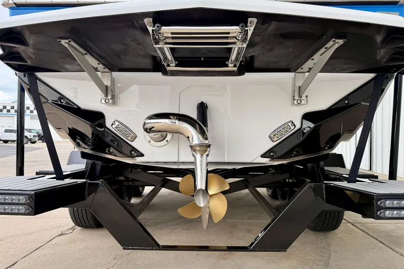 Slide: The Image of 2025 Nautique Super Air Nautique GS24 boat stern with propeller and trailer. - 5