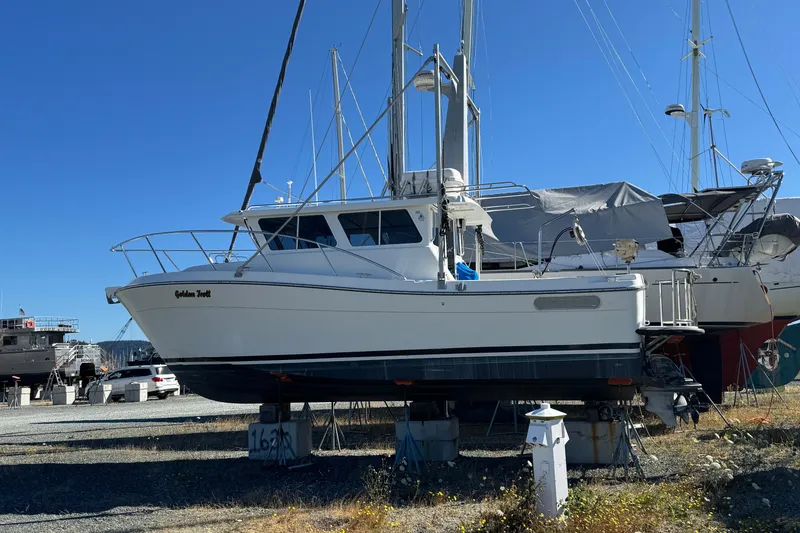 Slide: The Image of 2005 Ocean Sport Roamer 30 boat on dry dock under clear blue sky. - 1
