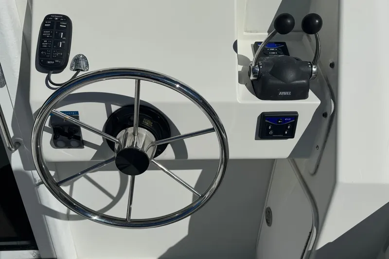 Slide: The Image of Steering wheel and controls of a 2005 Ocean Sport Roamer 30 boat. - 16