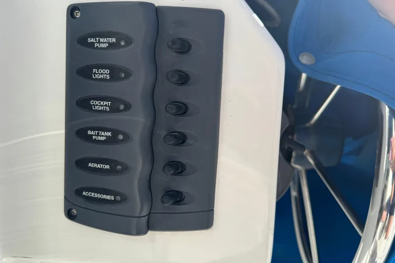 Slide: The Image of Control panel on a 2005 Ocean Sport Roamer 30 boat with labeled switches. - 17