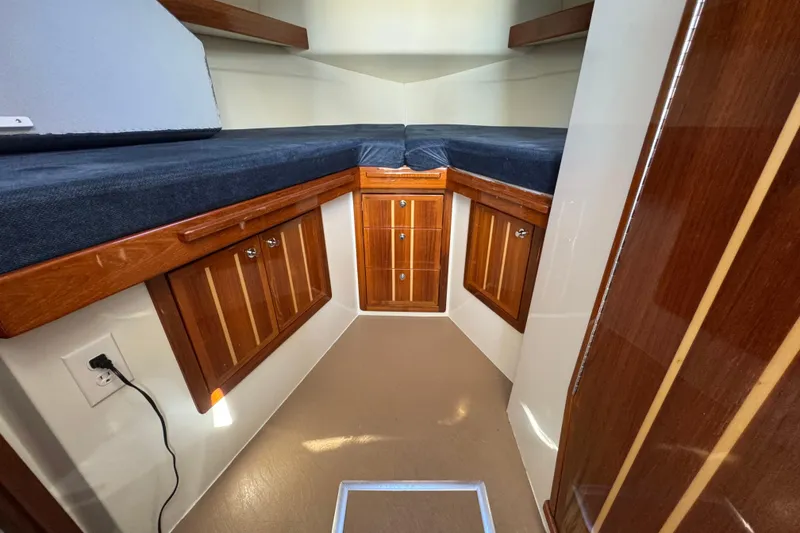 Slide: The Image of Interior cabin of 2005 Ocean Sport Roamer 30 with wooden storage and seating. - 19