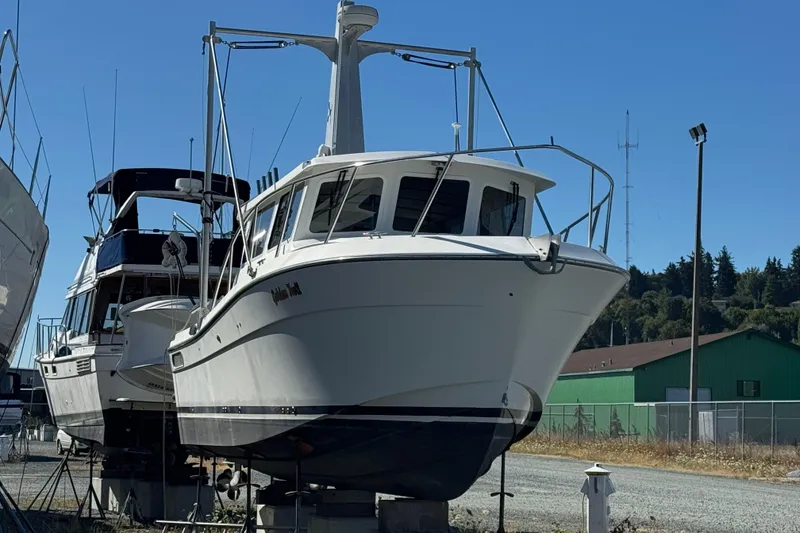 Slide: The Image of 2005 Ocean Sport Roamer 30 boat on dry dock under clear blue sky. - 2