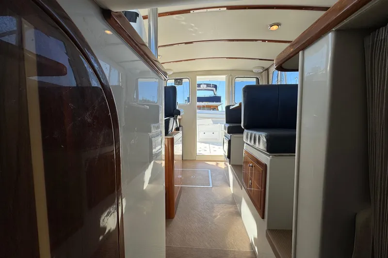 Slide: The Image of Interior view of 2005 Ocean Sport Roamer 30 boat, featuring seating and cabinetry. - 22
