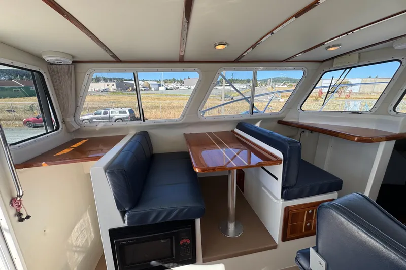 Slide: The Image of Interior of 2005 Ocean Sport Roamer 30 boat with seating and windows. - 23