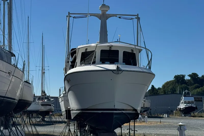 Slide: The Image of 2005 Ocean Sport Roamer 30 boat on dry dock under clear blue sky. - 3