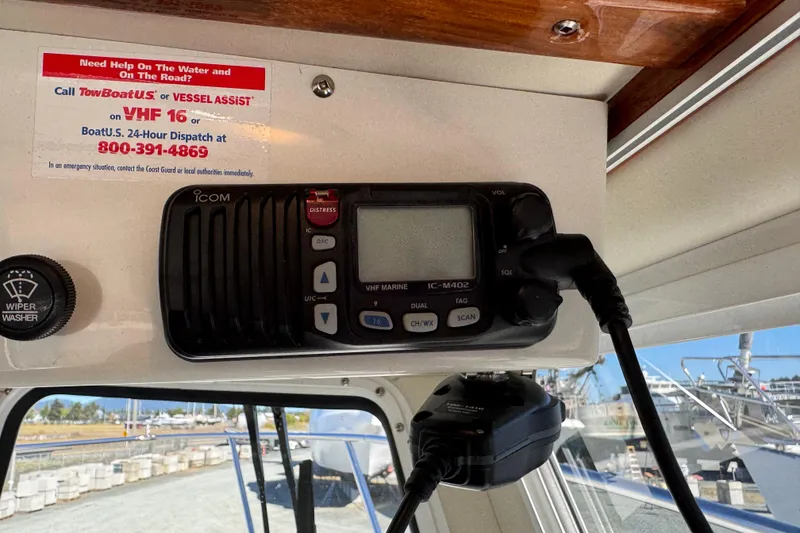 Slide: The Image of VHF radio on 2005 Ocean Sport Roamer 30 boat, with emergency contact information displayed. - 33