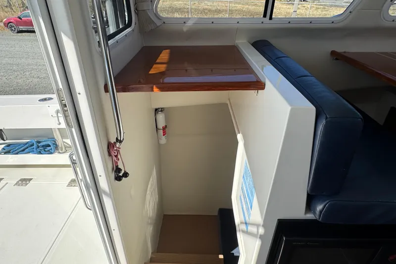 Slide: The Image of Interior view of 2005 Ocean Sport Roamer 30 boat with seating and stairs. - 35