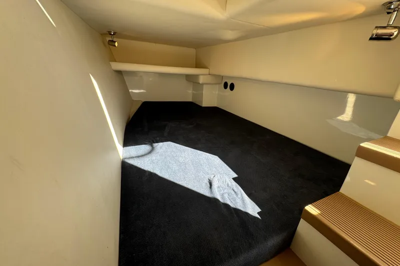 Slide: The Image of Interior cabin of 2005 Ocean Sport Roamer 30 with carpeted flooring and steps. - 36