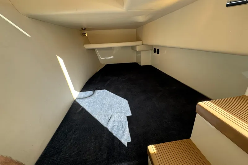 Slide: The Image of 2005 Ocean Sport Roamer 30 interior cabin with carpeted floor and wooden steps. - 37