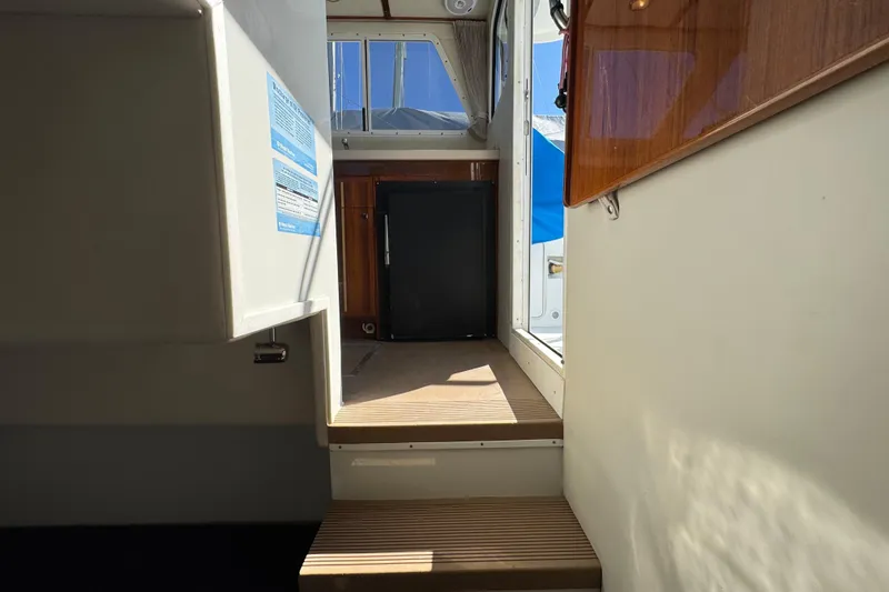 Slide: The Image of Interior view of 2005 Ocean Sport Roamer 30 boat, featuring steps and a compact cabin area. - 38