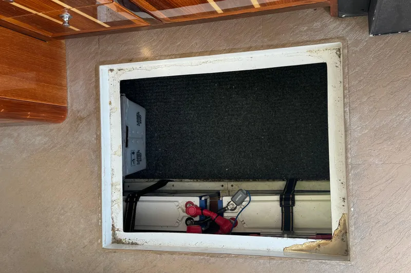 Slide: The Image of Hatch opening on 2005 Ocean Sport Roamer 30 boat, revealing storage compartment. - 39