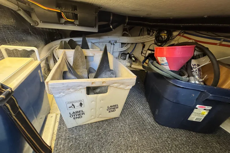 Slide: The Image of Storage area in a 2005 Ocean Sport Roamer 30 boat with equipment and containers. - 40