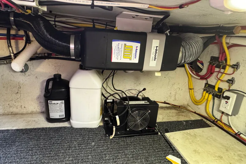 Slide: The Image of Engine room of 2005 Ocean Sport Roamer 30 with heating and electrical systems. - 42