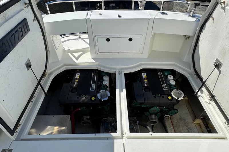 Slide: The Image of Engine compartment of a 2005 Ocean Sport Roamer 30 boat, showcasing dual engines. - 48
