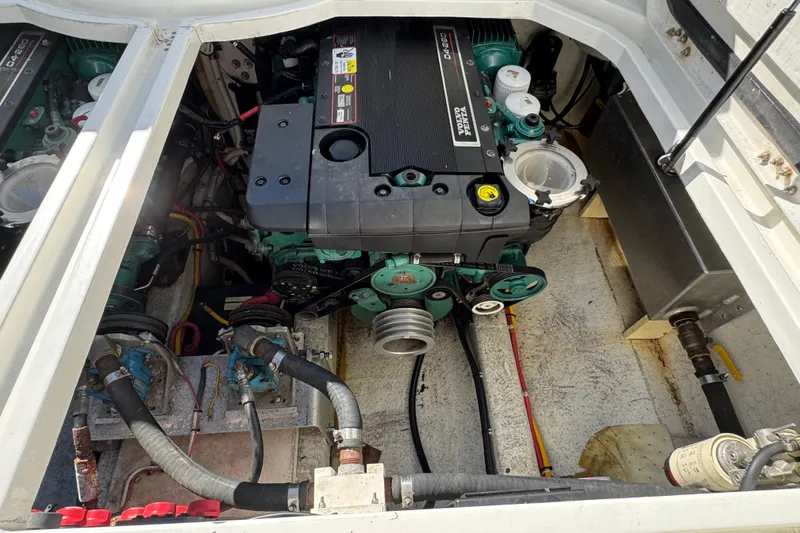Slide: The Image of Engine compartment of a 2005 Ocean Sport Roamer 30, featuring a Volvo Penta engine. - 51