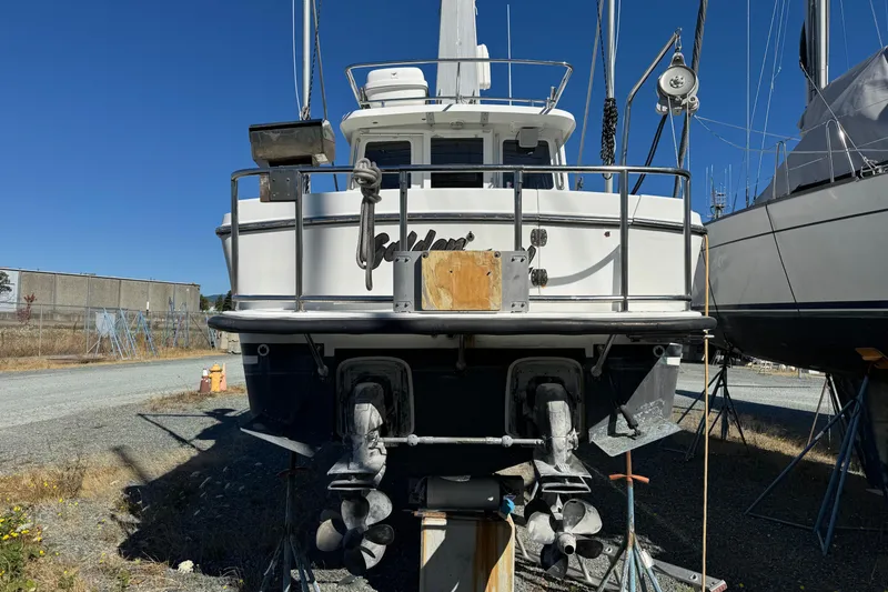 Slide: The Image of 2005 Ocean Sport Roamer 30 boat on dry dock, rear view with dual propellers. - 6