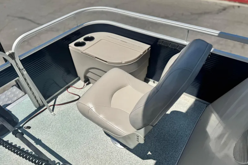 Slide: The Image of 2019 Bennington 188 SV boat interior with beige captain's chair and storage console. - 13