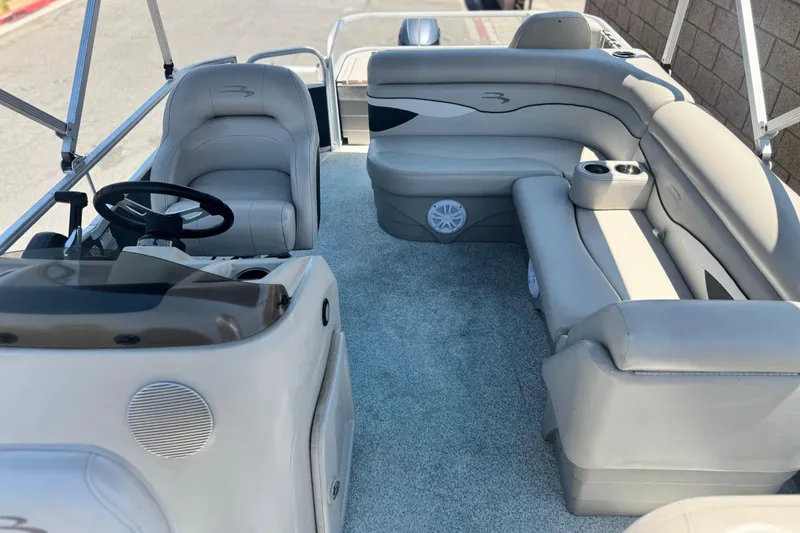 Slide: The Image of 2019 Bennington 188 SV pontoon boat interior with plush seating and steering console. - 15