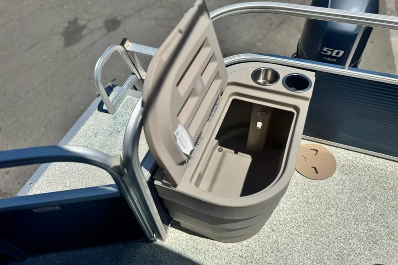 Slide: The Image of Open storage compartment on 2019 Bennington 188 SV boat with cup holders. - 18