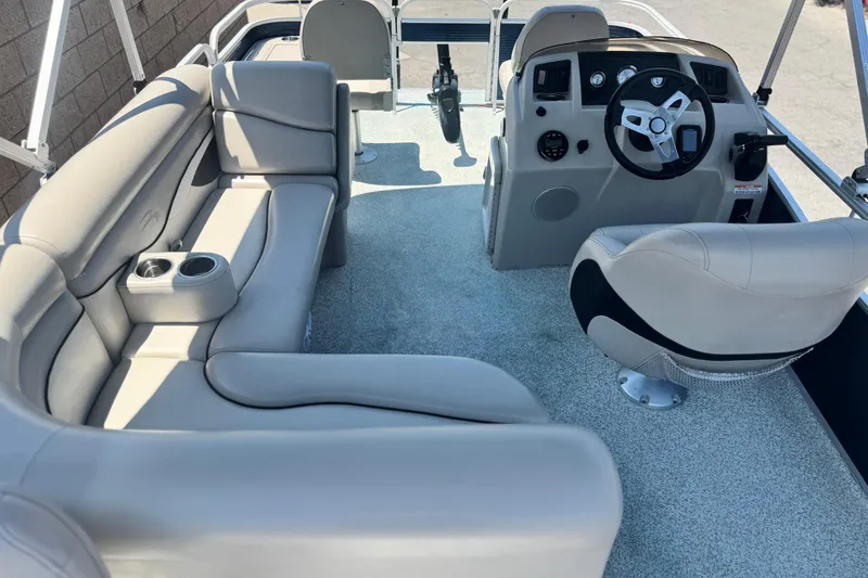 Slide: The Image of 2019 Bennington 188 SV boat interior with plush seating and modern steering console. - 19